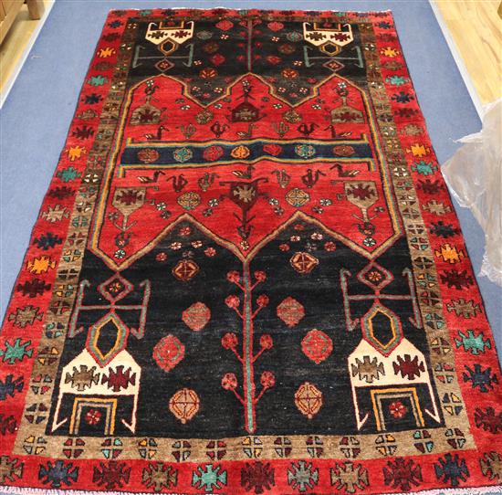 An Afshar red and black ground rug, 7ft 11in by 4ft 8in.